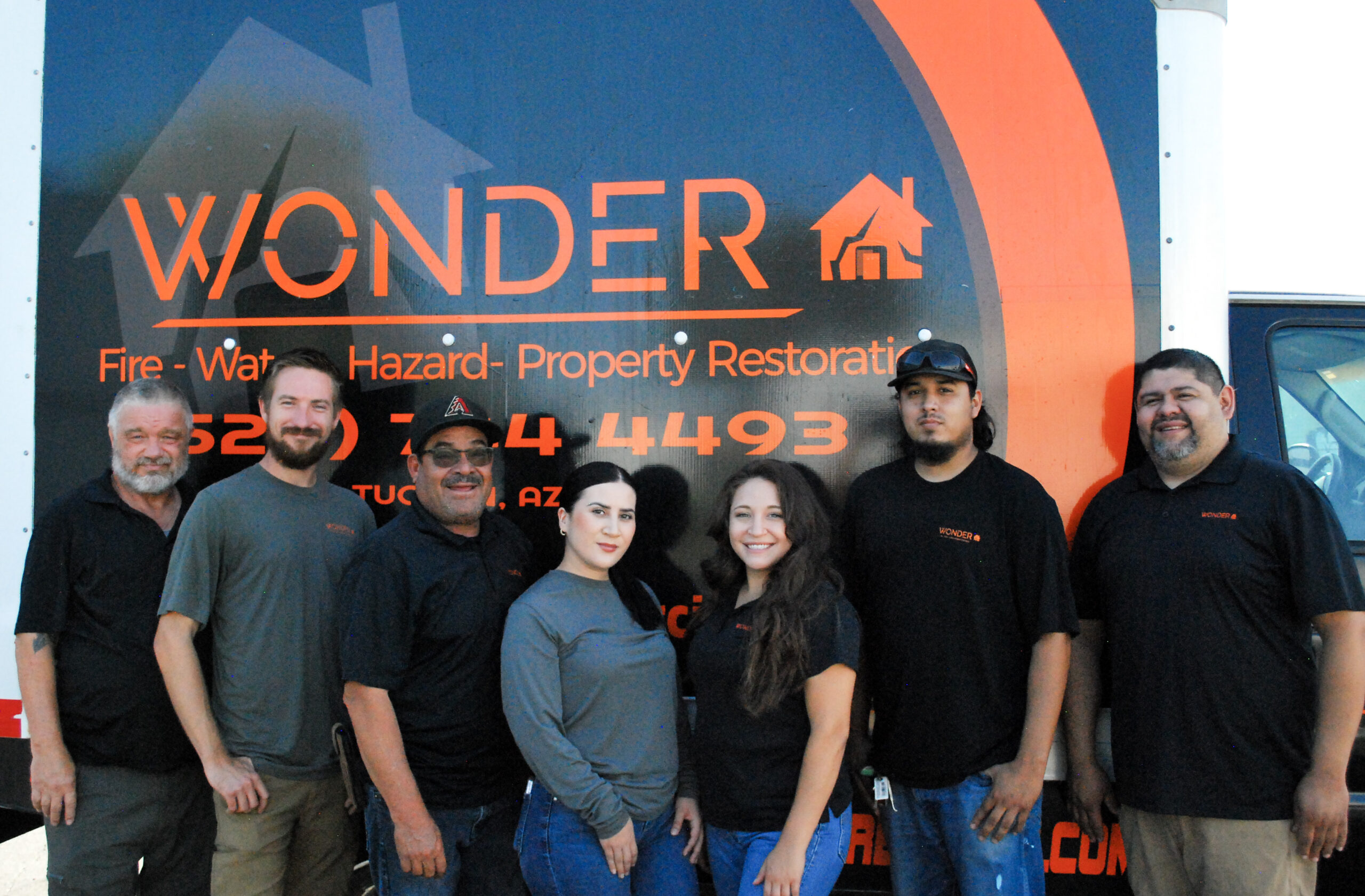 wonder restoration team in front of truck